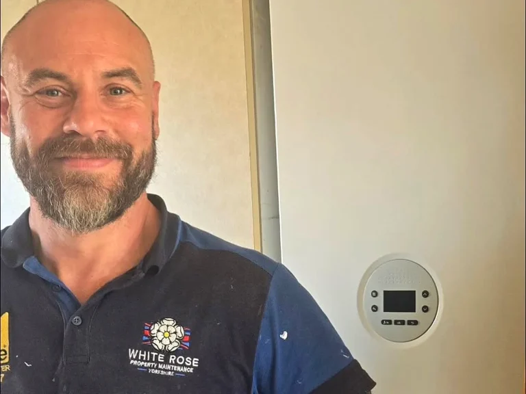 White Rose Gas Safe engineer next to a Worcester Bosch boiler in Leeds